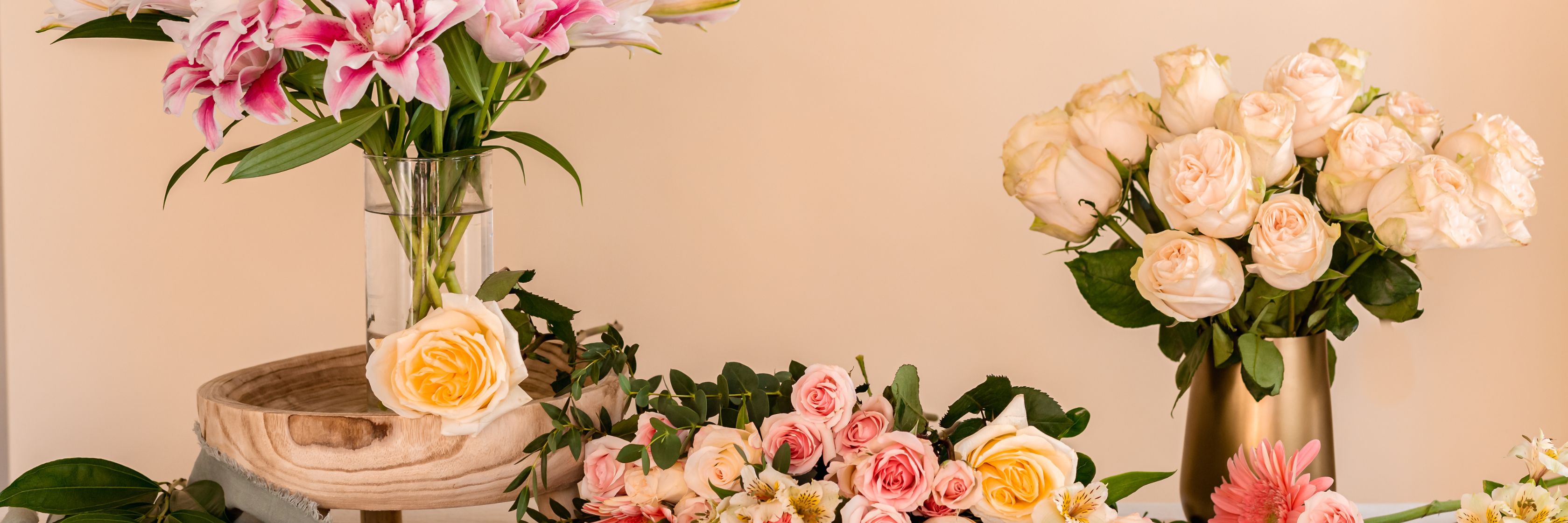 A stunning display of mixed roses and lilies in elegant vases, perfect for decor.