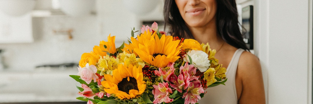 Bright and cheerful bouquet featuring sunflowers, pink lilies, and white blooms, ideal for celebrations.