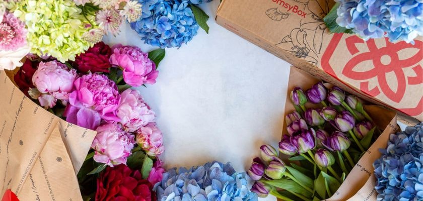 Vibrant floral arrangement with peonies, hydrangeas, and tulips in a stylish packaging.