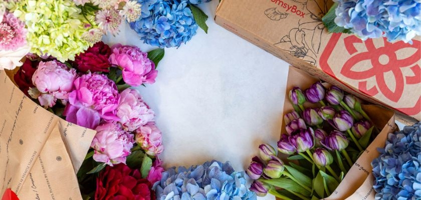 Vibrant floral arrangement with peonies, hydrangeas, and tulips in a stylish packaging.
