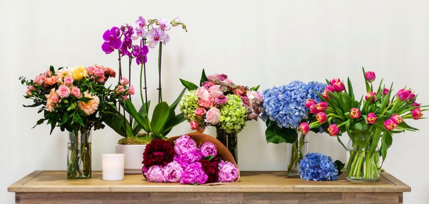 A vibrant display of mixed floral arrangements in elegant vases, perfect for events.