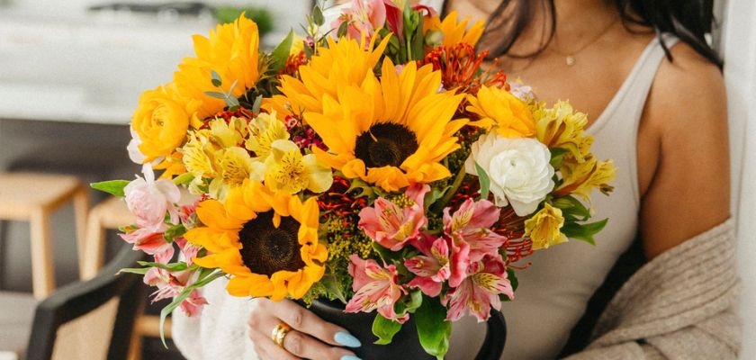 Bright sunflower bouquet with pink and yellow blooms, ideal for sunny celebrations.