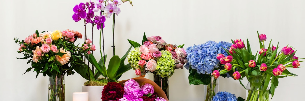 Vibrant floral display with roses, orchids, and tulips in elegant arrangements for any occasion.
