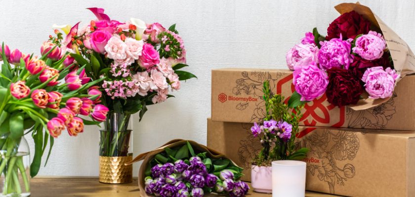 Vibrant floral arrangements featuring tulips, peonies, and roses in stylish packaging.