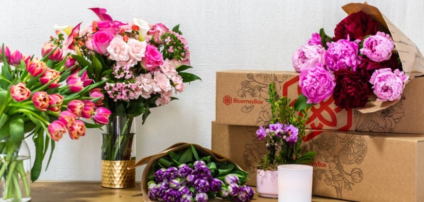 Vibrant floral arrangements featuring tulips, peonies, and roses in stylish packaging.