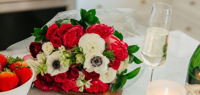 Vibrant bouquet of red roses and white anemones, perfect for celebrations.