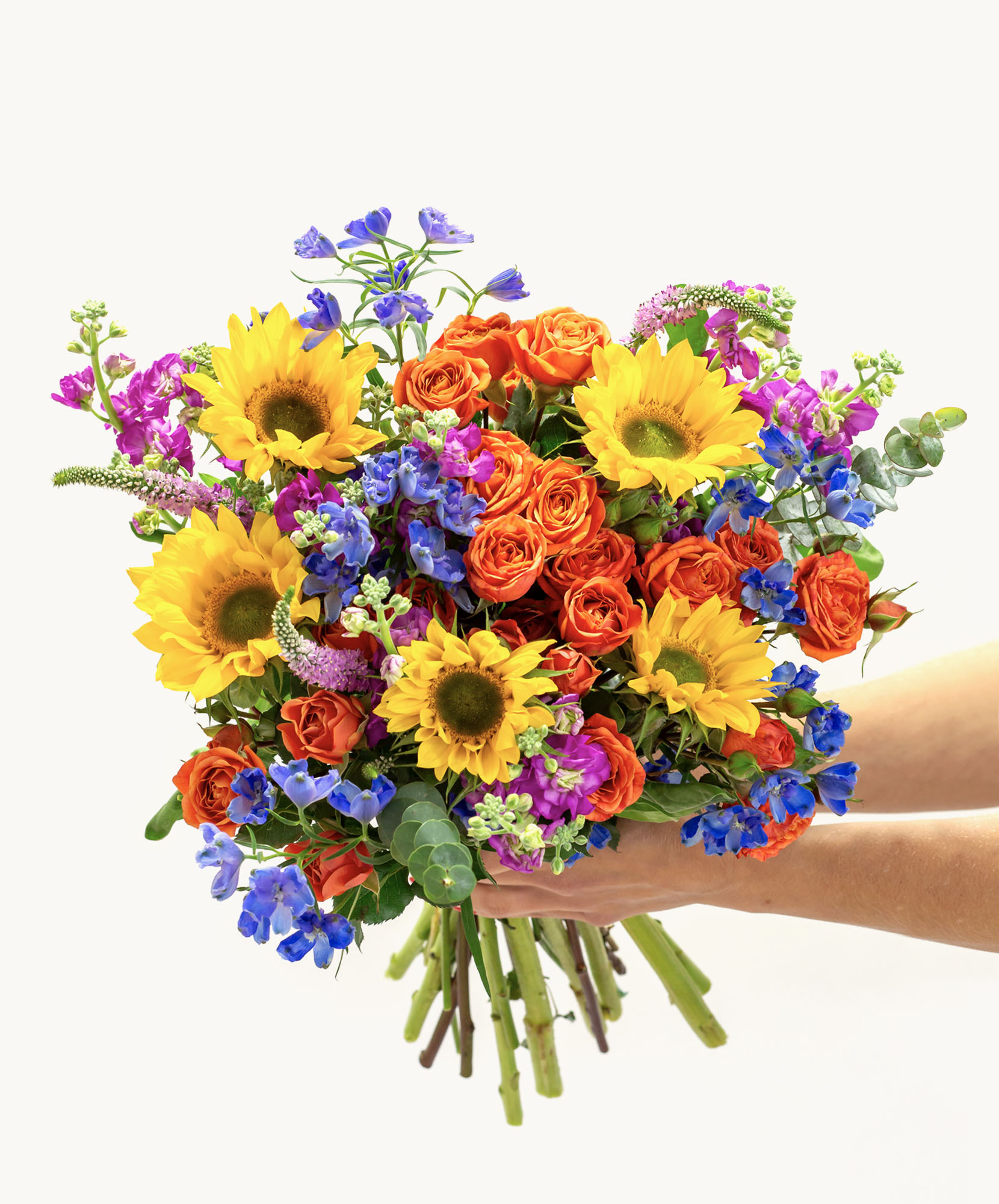 Bright floral bouquet featuring sunflowers and vibrant roses in assorted colors.