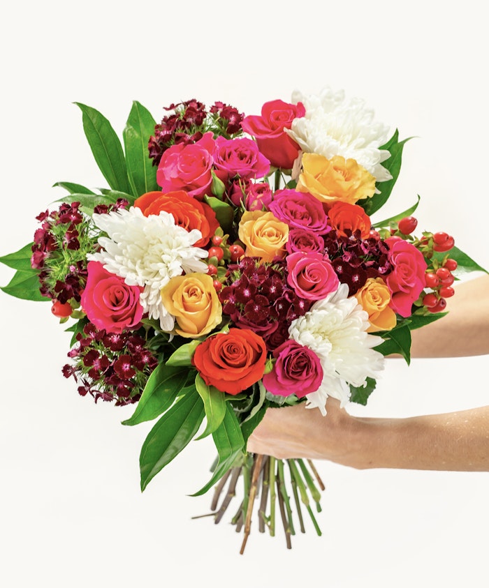 Vibrant mixed flower bouquet featuring roses, chrysanthemums, and lush greenery.