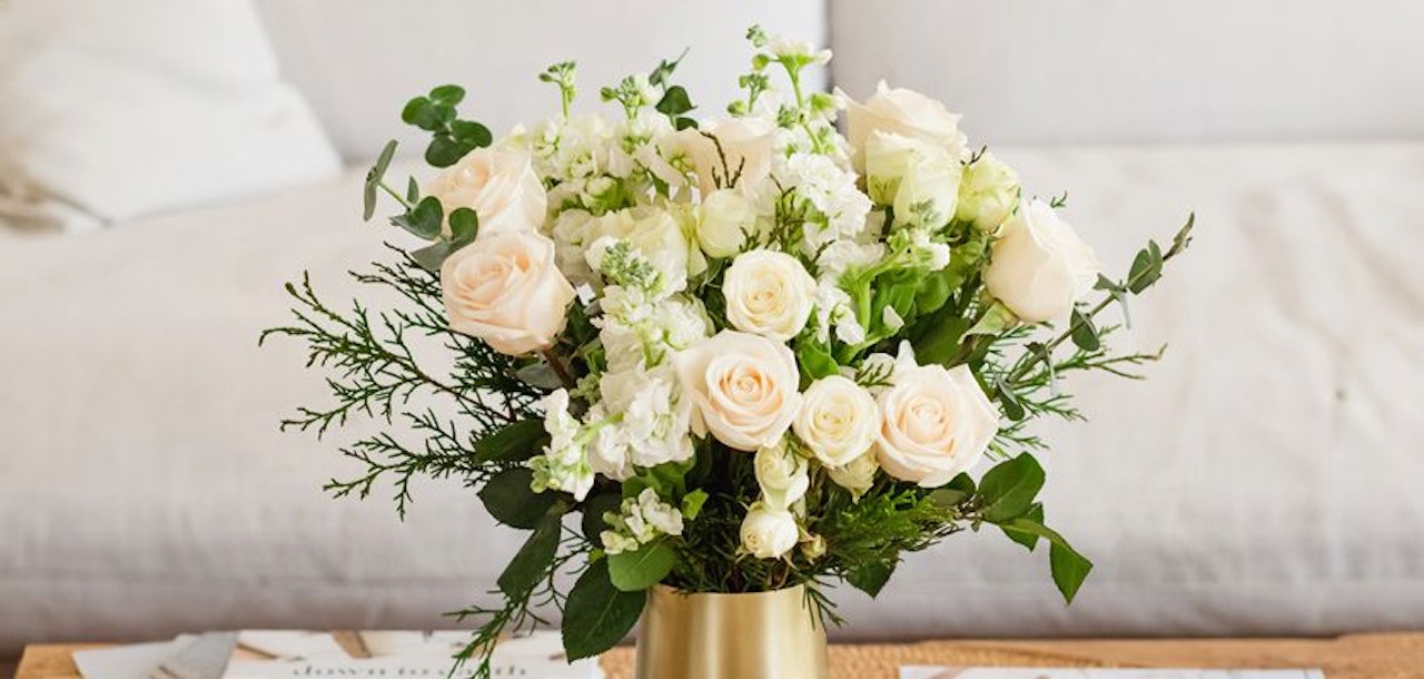 Elegant bouquet featuring soft pink roses and white blooms in a chic arrangement.