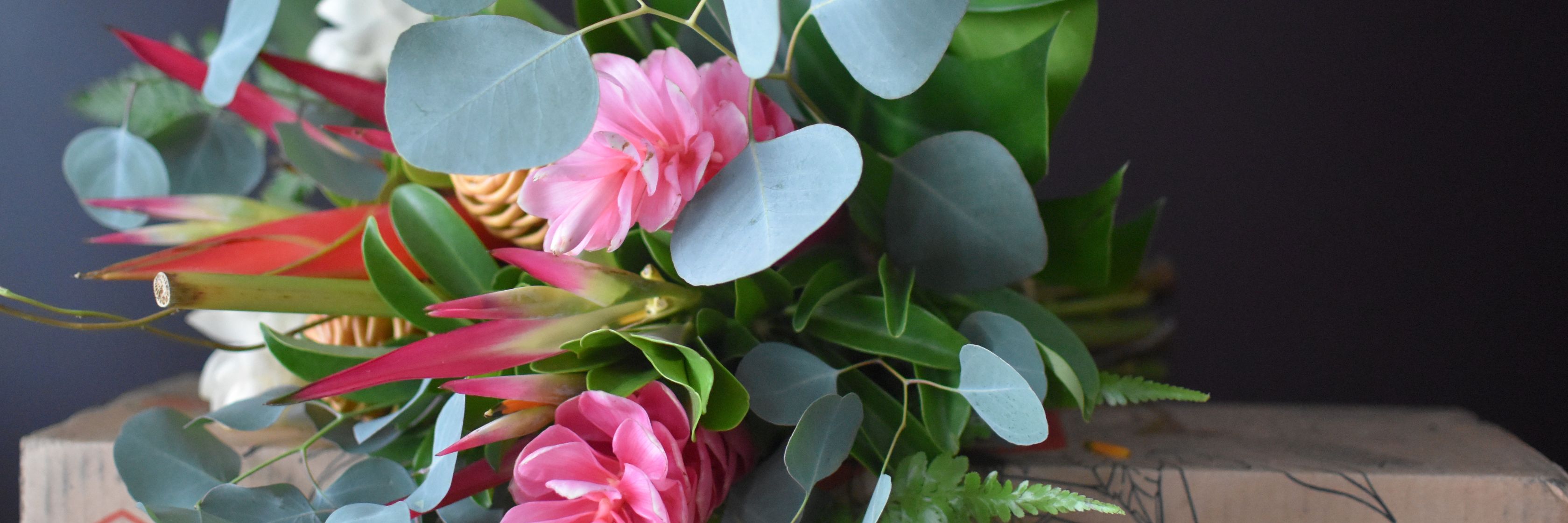 Vibrant bouquet featuring pink flowers and lush green foliage, perfect for brightening any space.