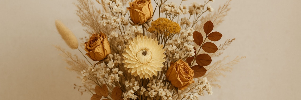Dried flower arrangement featuring yellow roses, vibrant blooms, and delicate foliage.