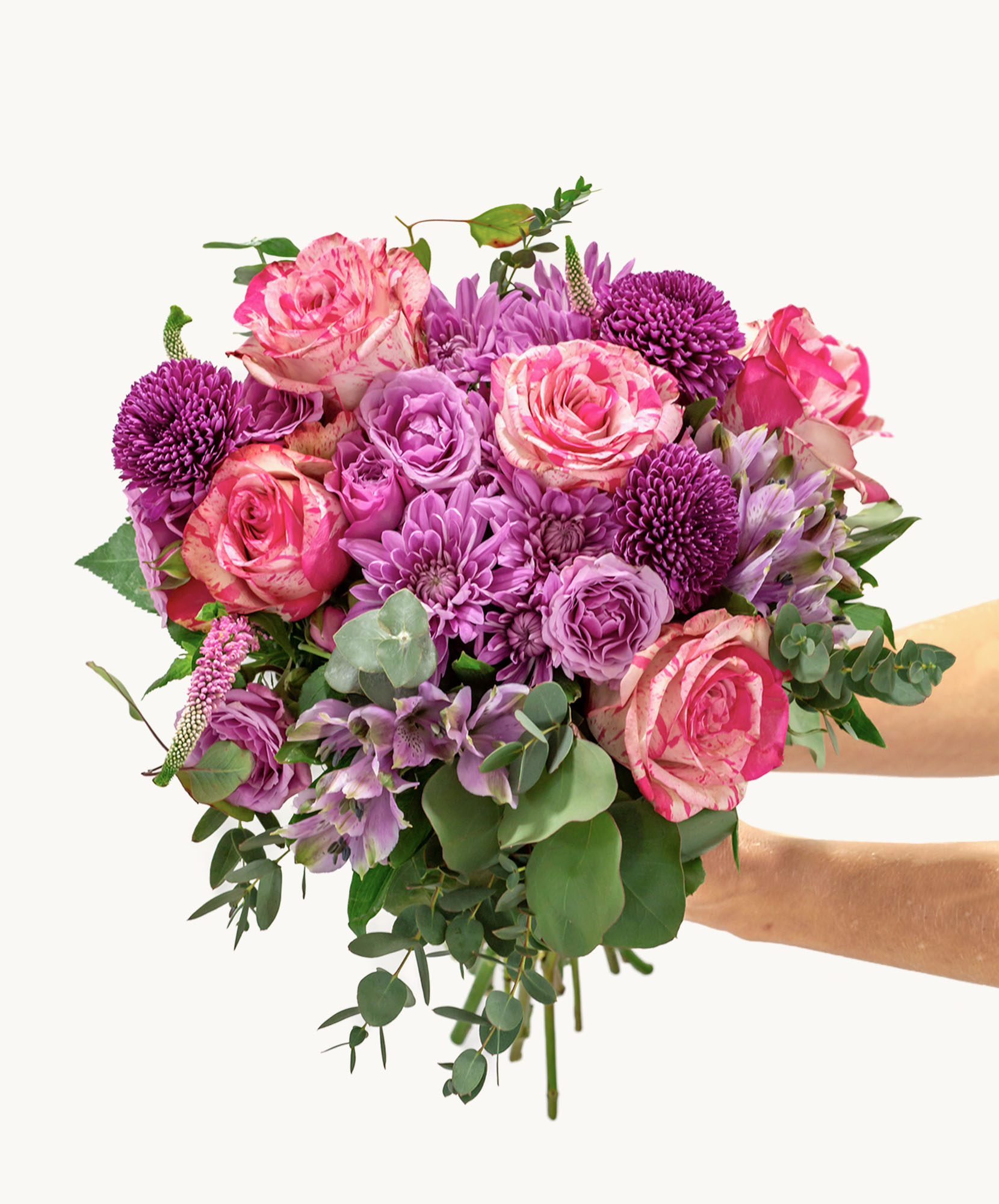 Vibrant bouquet of pink and purple roses, chrysanthemums, and greenery for special occasions.