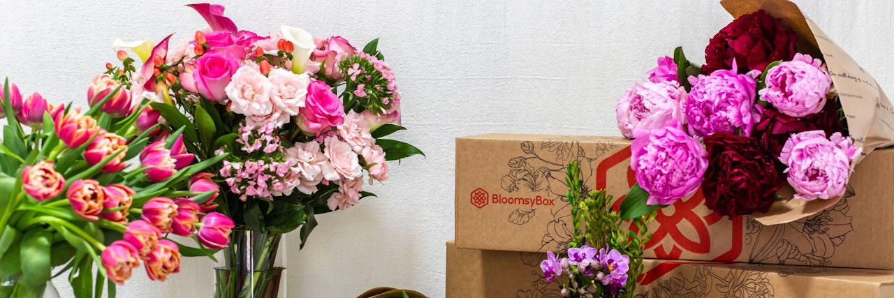 Colorful floral arrangements featuring roses, tulips, and peonies in stylish vases.