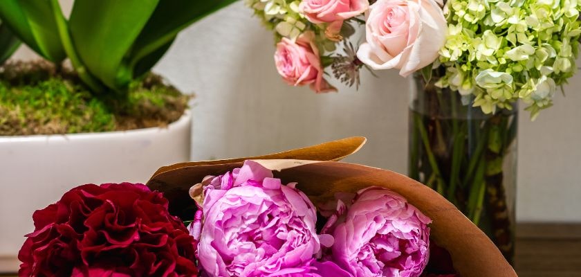 A vibrant floral arrangement featuring pink peonies and roses, perfect for any occasion.