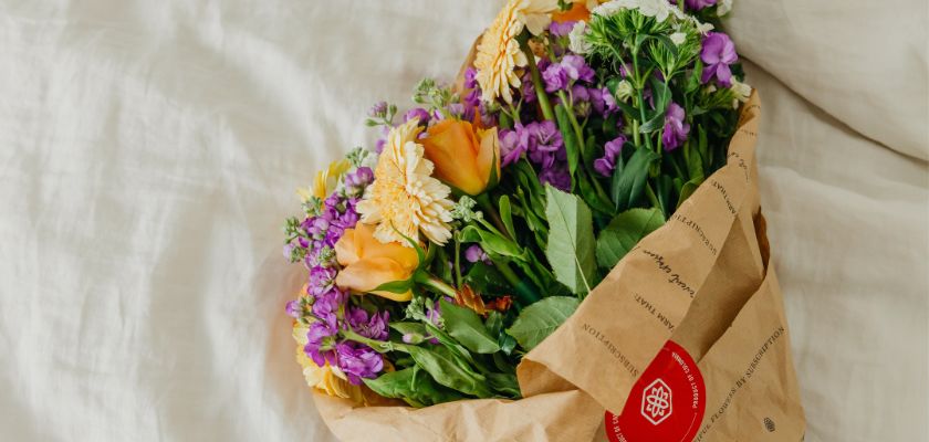 Vibrant bouquet of mixed flowers wrapped in craft paper, perfect for brightening any space.