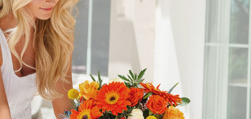 A vibrant bouquet of orange gerberas and roses, perfect for cheerful celebrations.