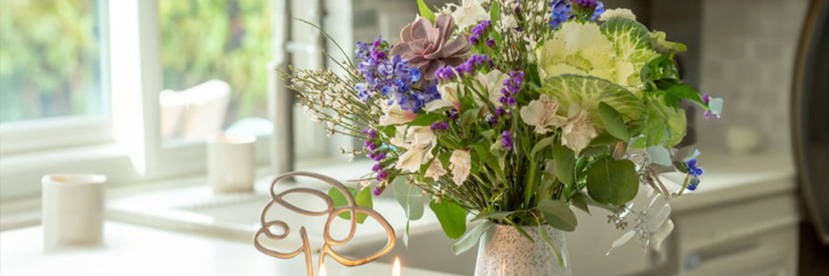 A vibrant floral arrangement featuring assorted blooms in a stylish vase, brightening the room.