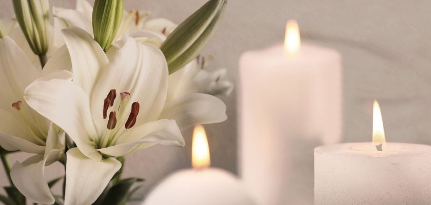 Elegant white lilies paired with soft candles create a serene and calming ambiance.