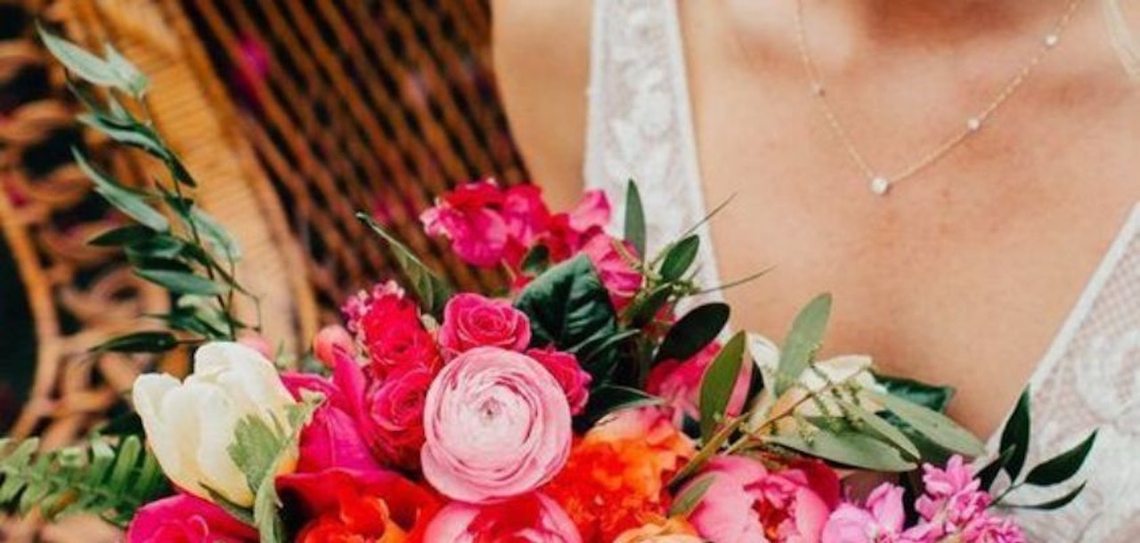 Vibrant floral bouquet featuring pink roses, tulips, and greenery for special occasions.