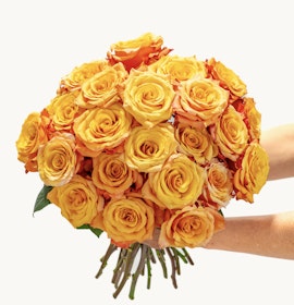 Vibrant bouquet of orange and yellow roses, perfect for cheerful celebrations and gifting.