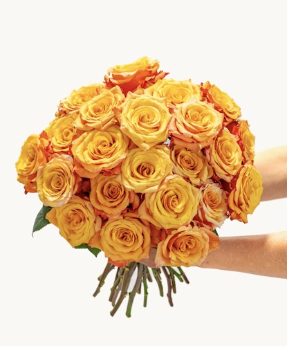 Vibrant bouquet of orange and yellow roses, perfect for cheerful celebrations and gifting.