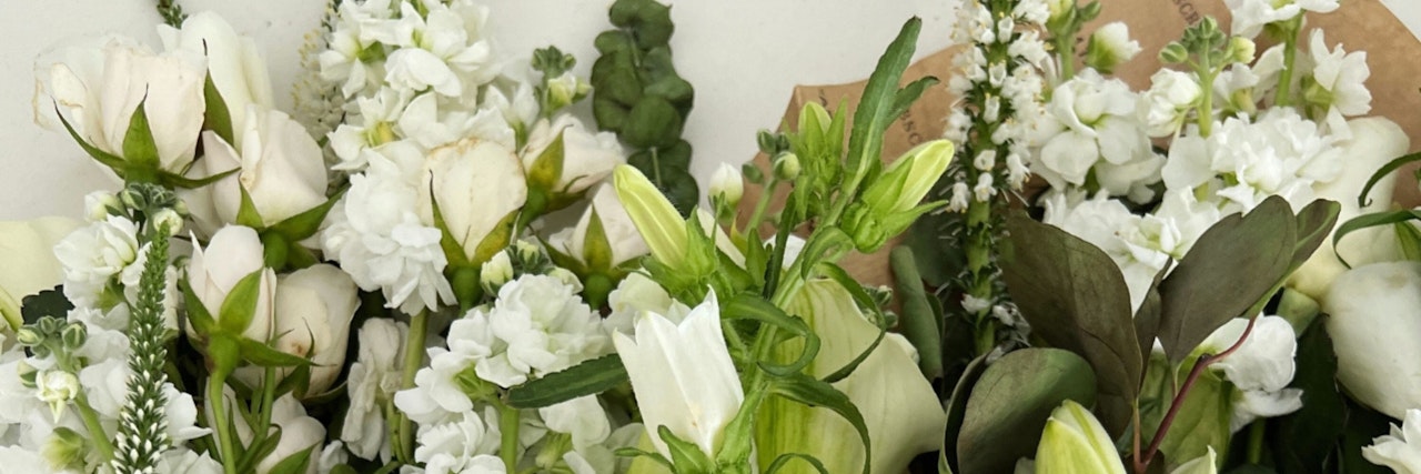 Elegant white flower bouquet featuring roses and delicate blooms, ideal for any occasion.