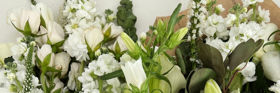 Elegant white flower bouquet featuring roses and delicate blooms, ideal for any occasion.