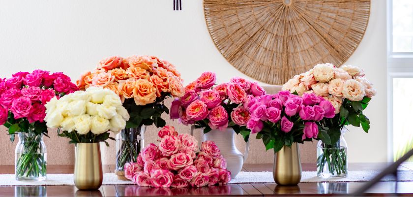 Vibrant floral display featuring assorted roses in pink, white, and peach hues, elegantly arranged.