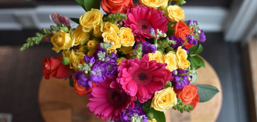 Vibrant floral bouquet featuring pink gerbera daisies and colorful roses, perfect for celebrations.