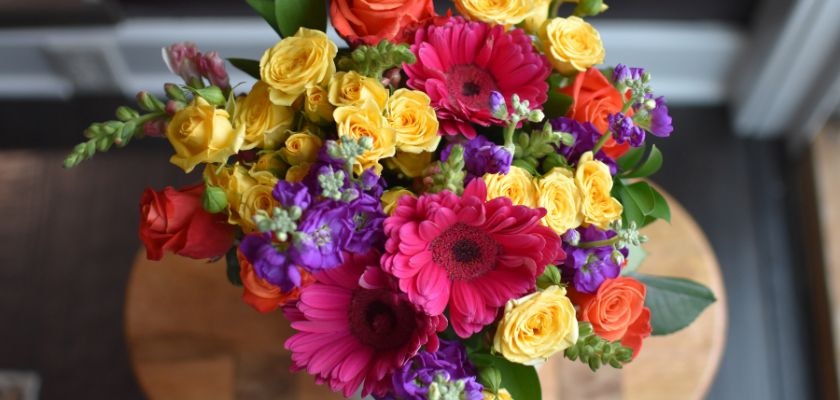 Vibrant floral bouquet featuring pink gerbera daisies and colorful roses, perfect for celebrations.