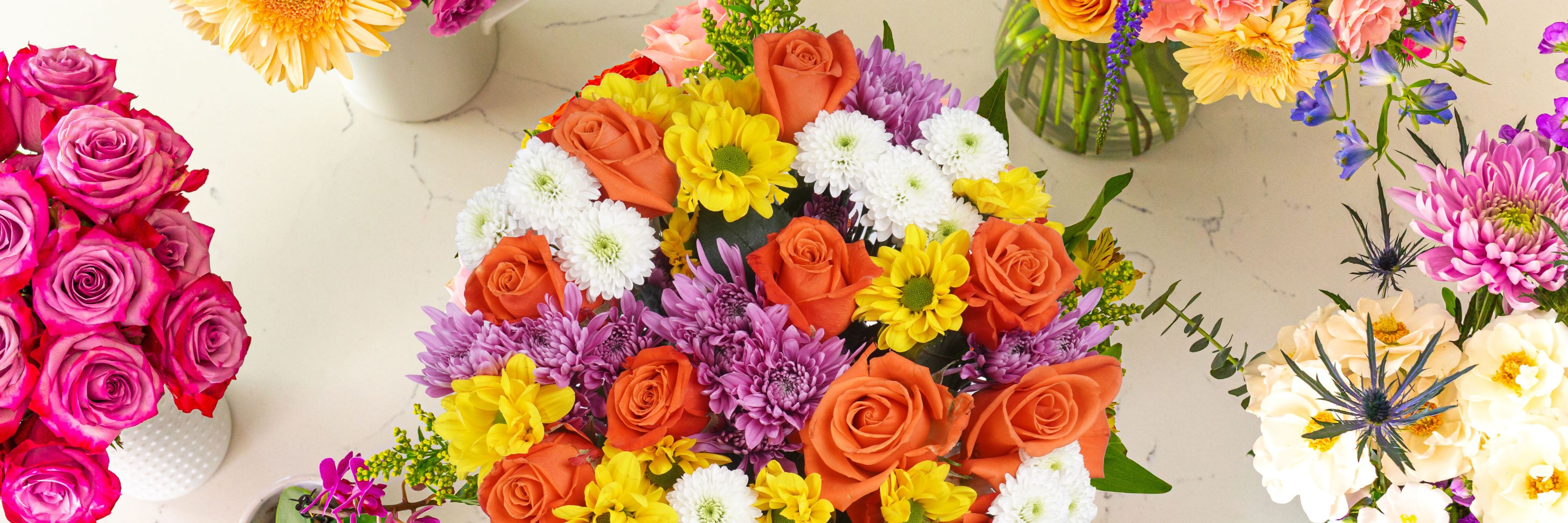 Vibrant floral arrangements featuring roses, daisies, and various colorful blooms.