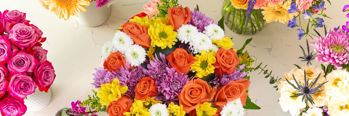 Vibrant floral arrangements featuring roses, daisies, and various colorful blooms.