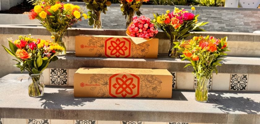 Colorful floral arrangements in glass vases, beautifully displayed on garden steps.