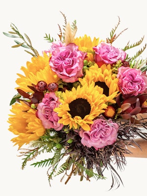 Vibrant bouquet featuring sunflowers and pink roses, perfect for cheerful occasions.