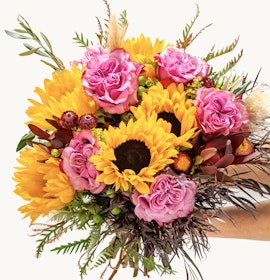 Vibrant bouquet featuring sunflowers and pink roses, perfect for cheerful occasions.