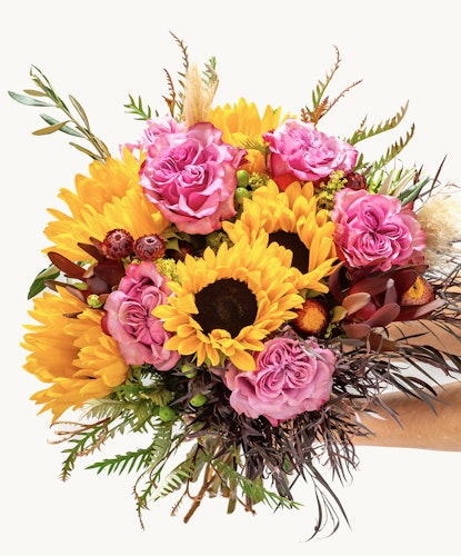 Vibrant bouquet featuring sunflowers and pink roses, perfect for cheerful occasions.