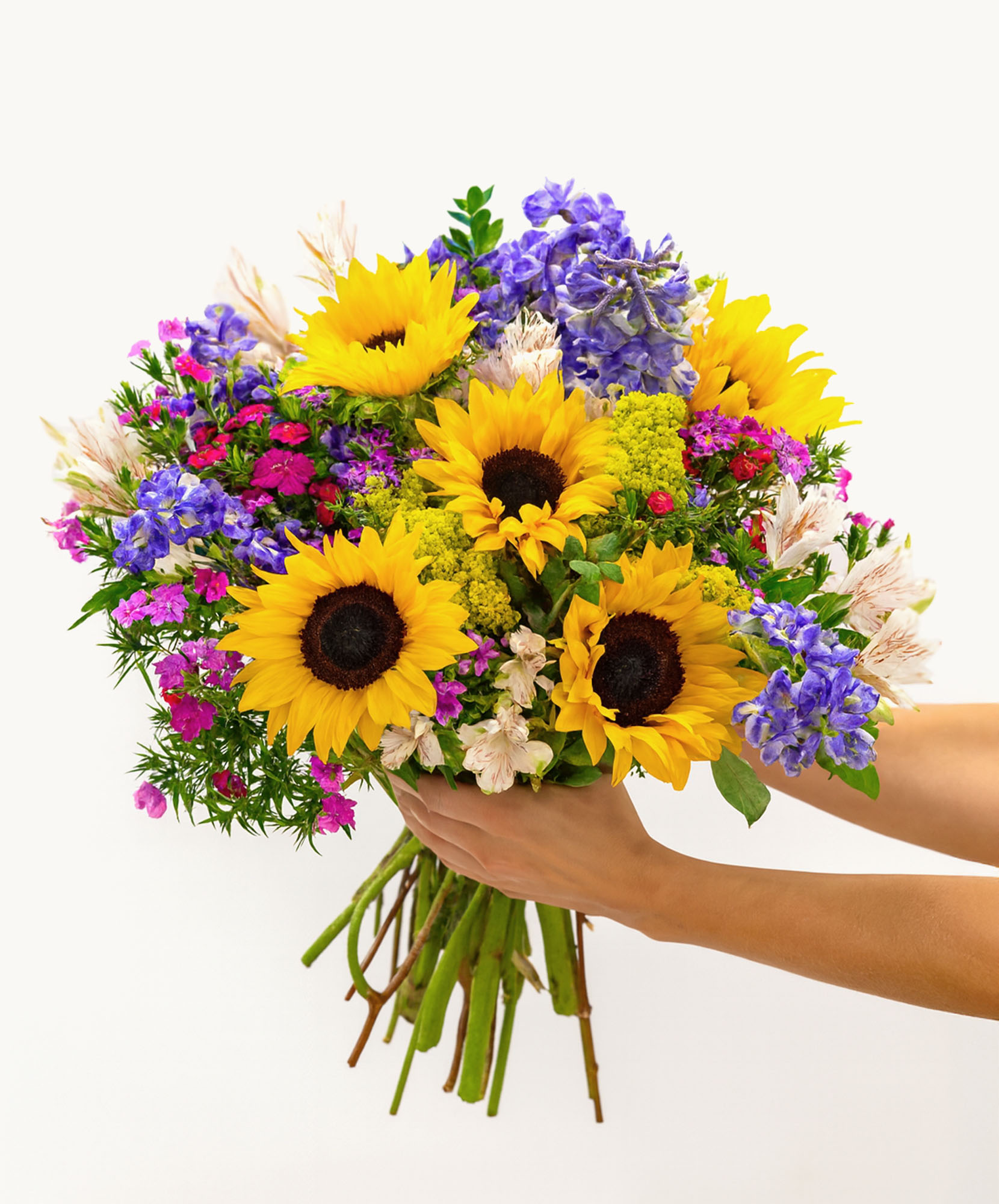 Vibrant bouquet featuring sunflowers, purple flowers, and pink accents, perfect for celebrations.