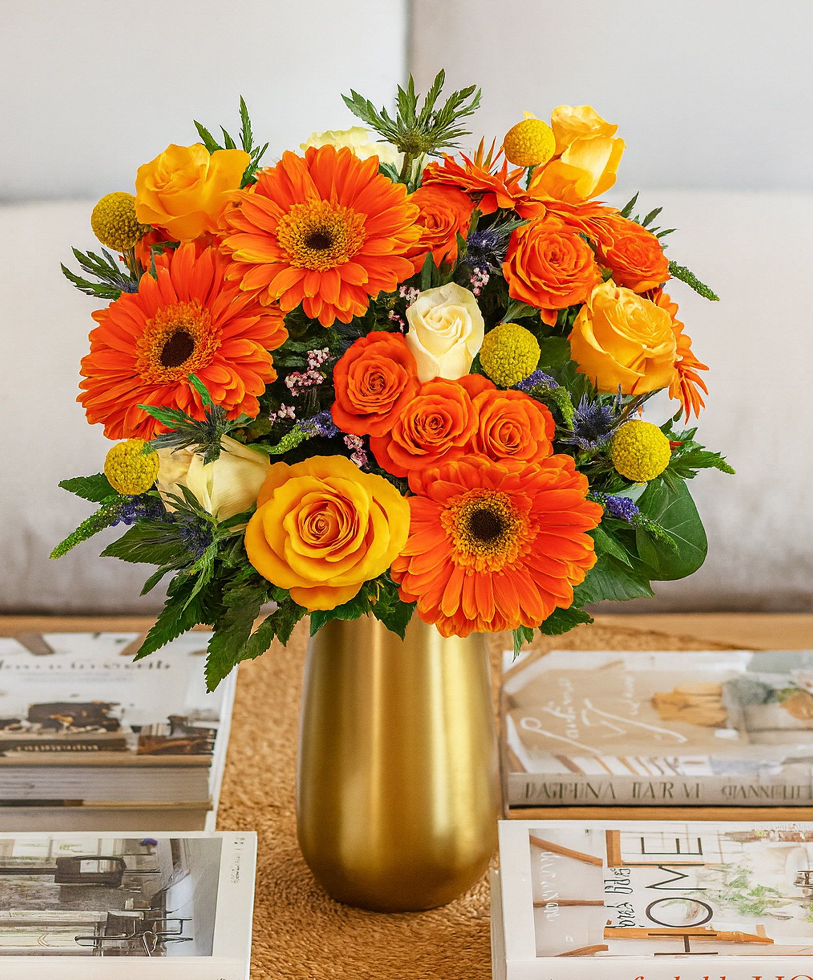 Bright and cheerful bouquet featuring orange gerberas, yellow roses, and vibrant blooms.