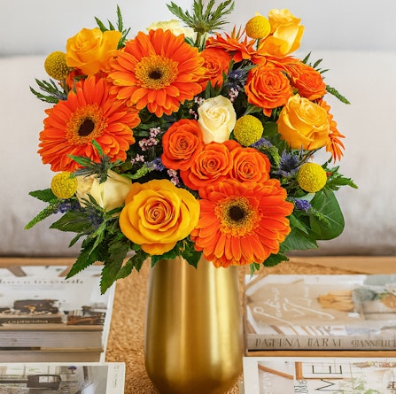 Bright and cheerful bouquet featuring orange gerberas, yellow roses, and vibrant blooms.