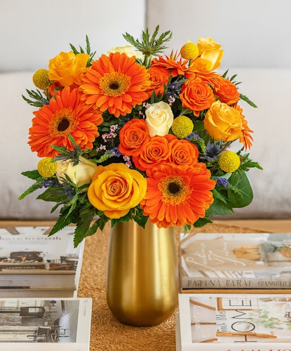 Bright and cheerful bouquet featuring orange gerberas, yellow roses, and vibrant blooms.