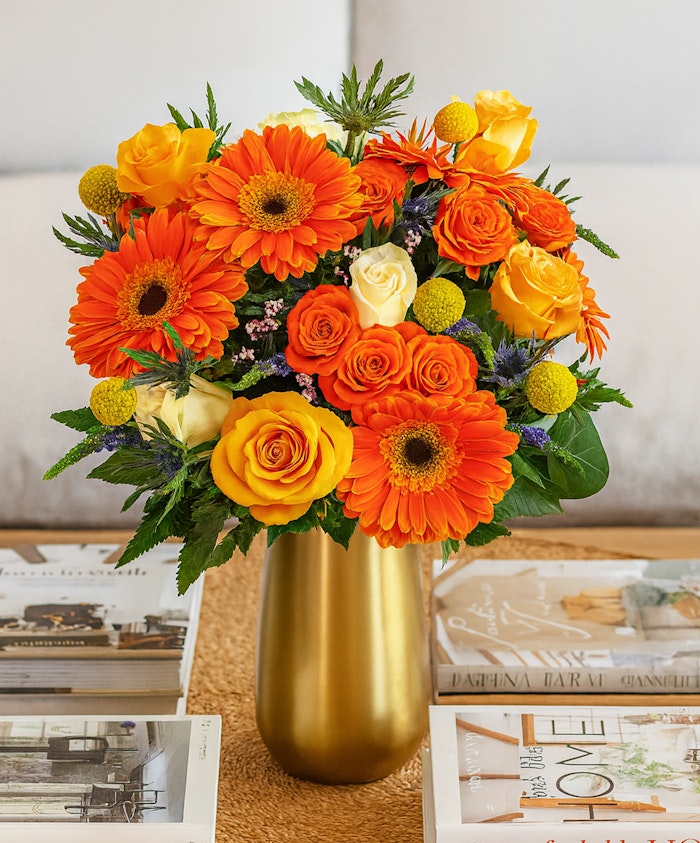 Bright and cheerful bouquet featuring orange gerberas, yellow roses, and vibrant blooms.