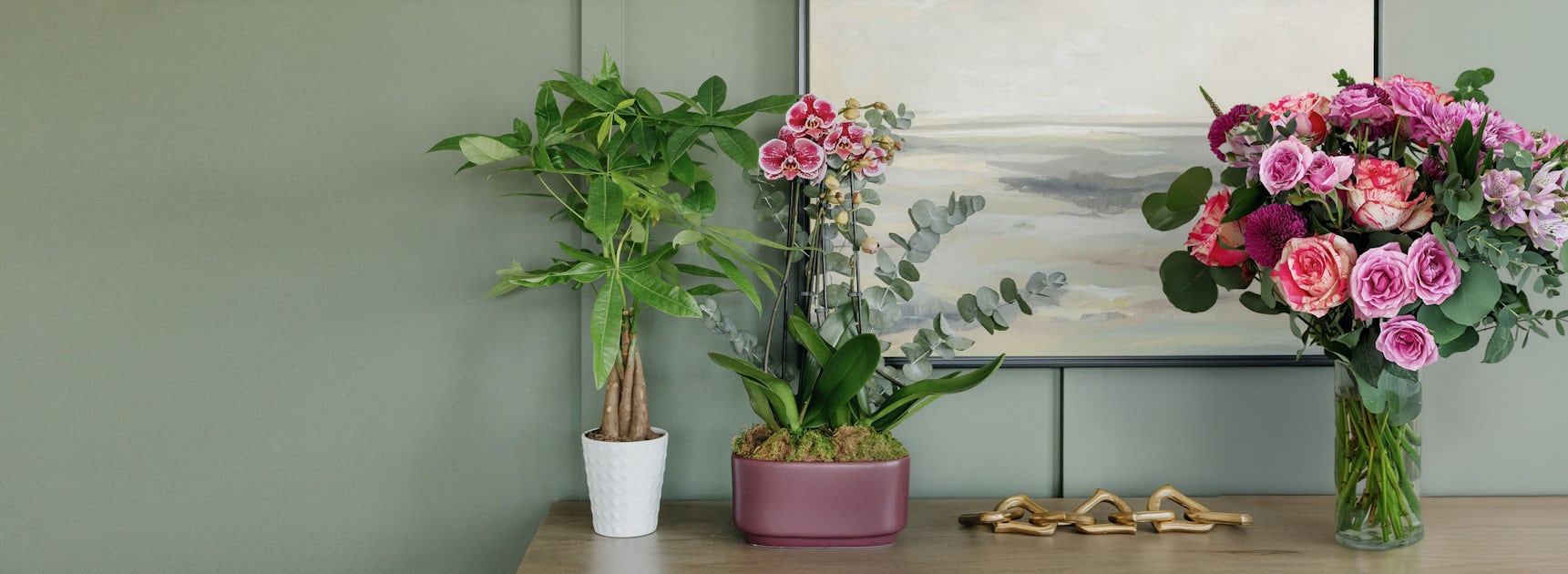 A vibrant floral arrangement with pink roses and orchids, adding elegance to a modern room.