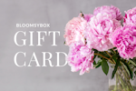 Elegant pink peonies in a vase, highlighting a BloomsbyBox gift card offer.