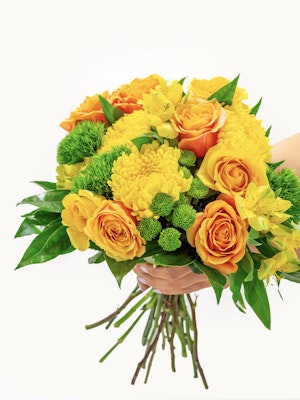 Vibrant bouquet featuring yellow roses, green accents, and mixed floral varieties.