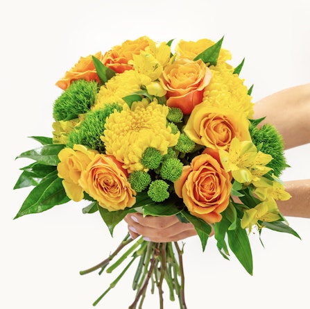 Vibrant bouquet featuring yellow roses, green accents, and mixed floral varieties.