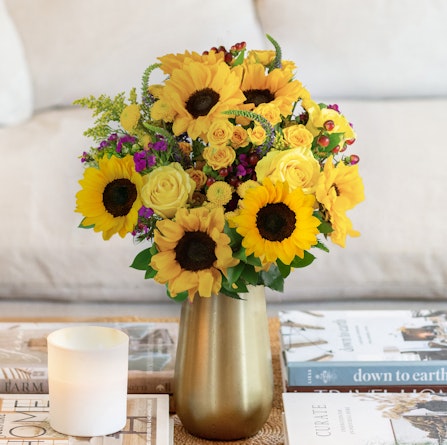 Bright and cheerful sunflower bouquet with yellow roses and vibrant accents, perfect for any occasion.