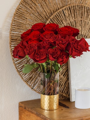 Vibrant red rose bouquet in a gold vase, perfect for home decor and special occasions.