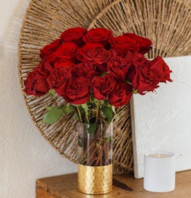Vibrant red rose bouquet in a gold vase, perfect for home decor and special occasions.