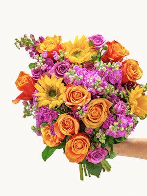 Vibrant mixed floral bouquet featuring sunflowers, roses, and colorful blossoms.