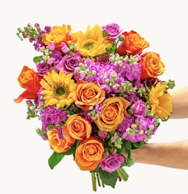 Vibrant mixed floral bouquet featuring sunflowers, roses, and colorful blossoms.